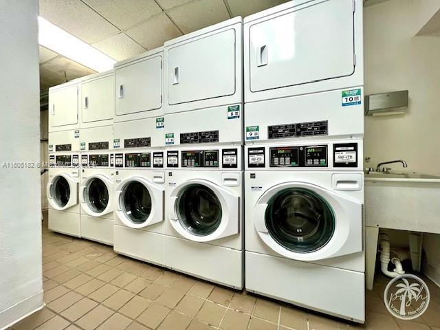 255 West 24th Street, Unit 308 Miami Beach, FL 33140 - Photo 24 of 31 a utility room with dryer washer and empty racks