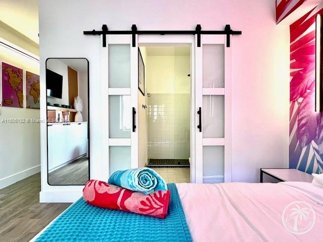255 West 24th Street, Unit 308 Miami Beach, FL 33140 - Photo 4 of 31 a bedroom with a bed and a table