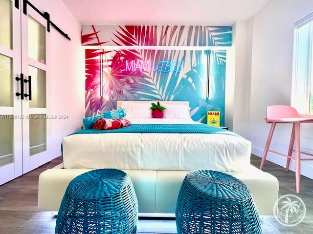 255 West 24th Street, Unit 308 Miami Beach, FL 33140 - Photo 8 of 31 a bedroom with a bed and a window