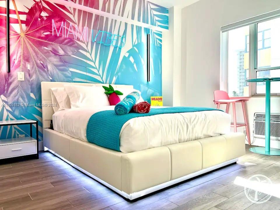 255 West 24th Street, Unit 308 Miami Beach, FL 33140 - Photo 9 of 31 a bed sitting in a bedroom next to a window