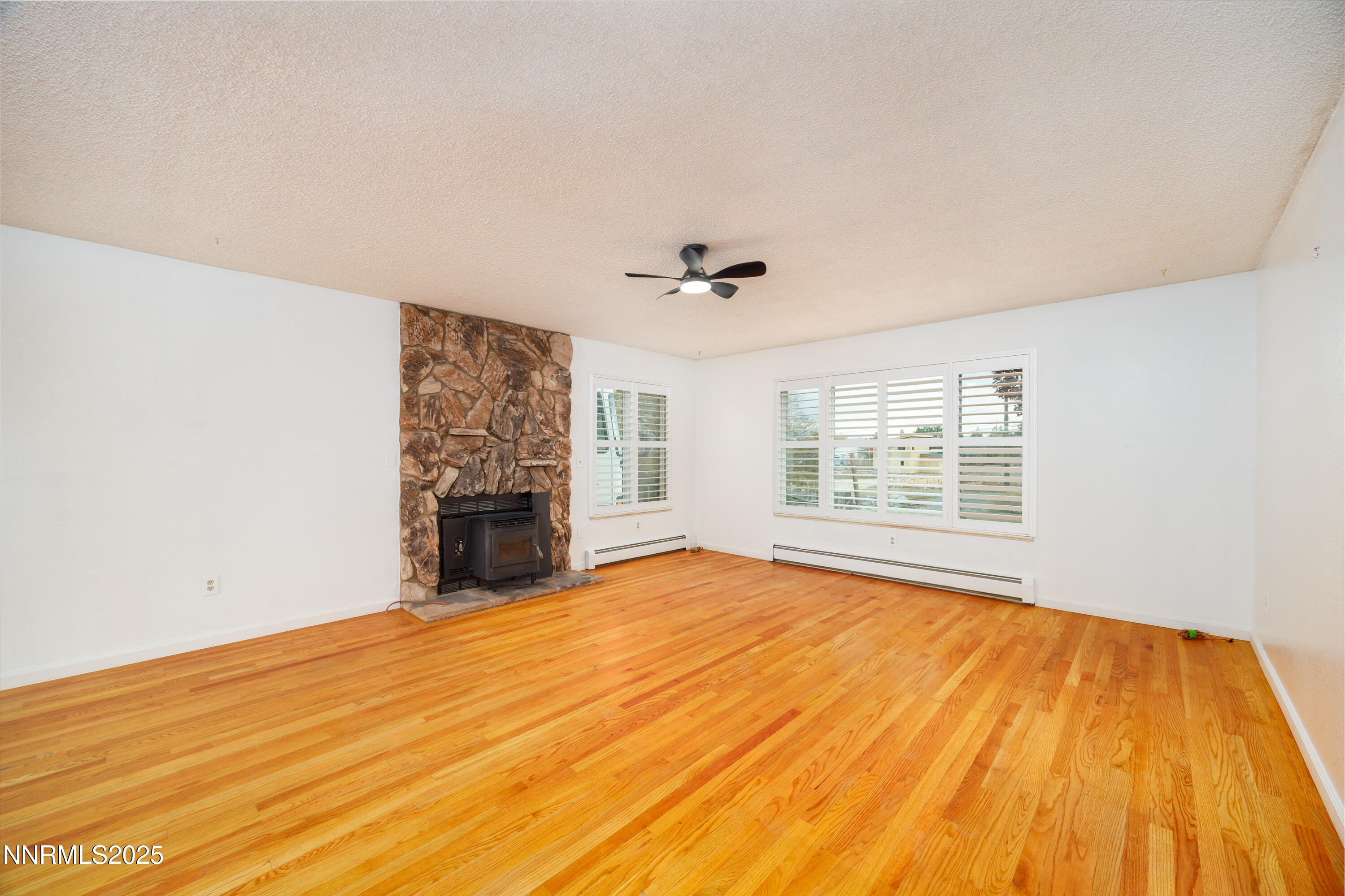 375 Hoge Road Reno, NV 89506 - Photo 3 of 36 a view of an empty room with a fireplace and a window
