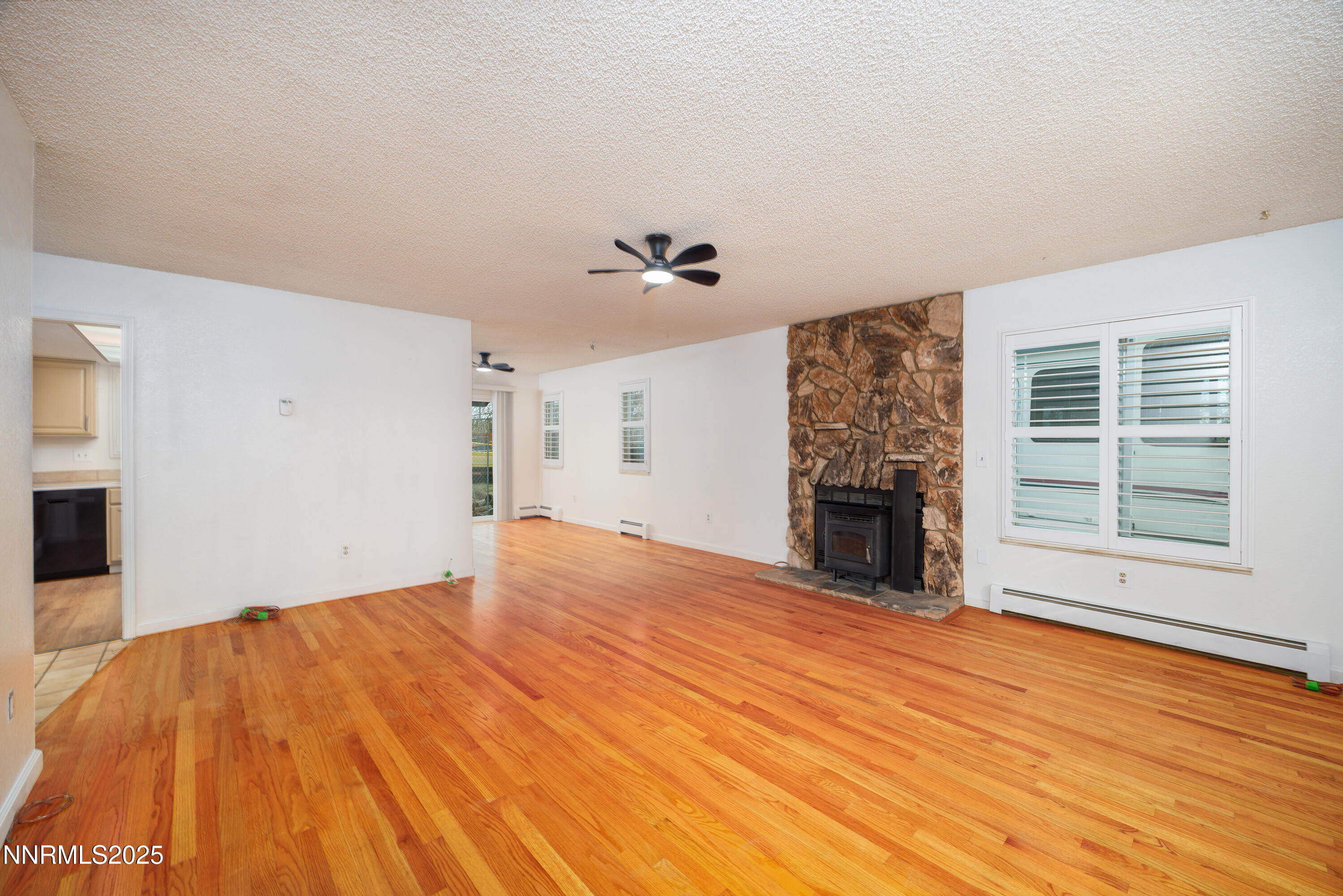 375 Hoge Road Reno, NV 89506 - Photo 5 of 36 a view of empty room with wooden floor and fireplace