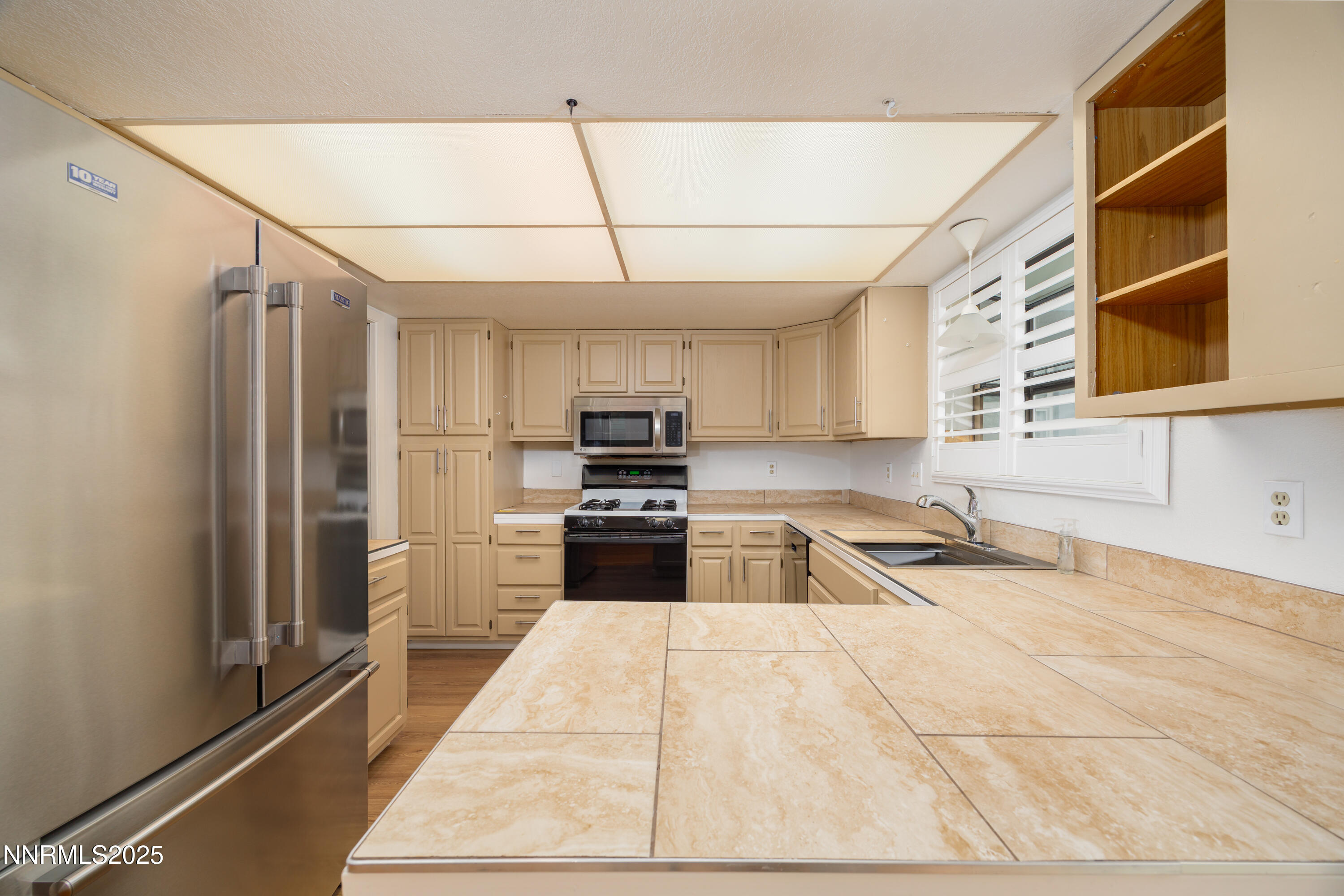 375 Hoge Road Reno, NV 89506 - Photo 7 of 36 a kitchen with stainless steel appliances granite countertop a refrigerator and a sink
