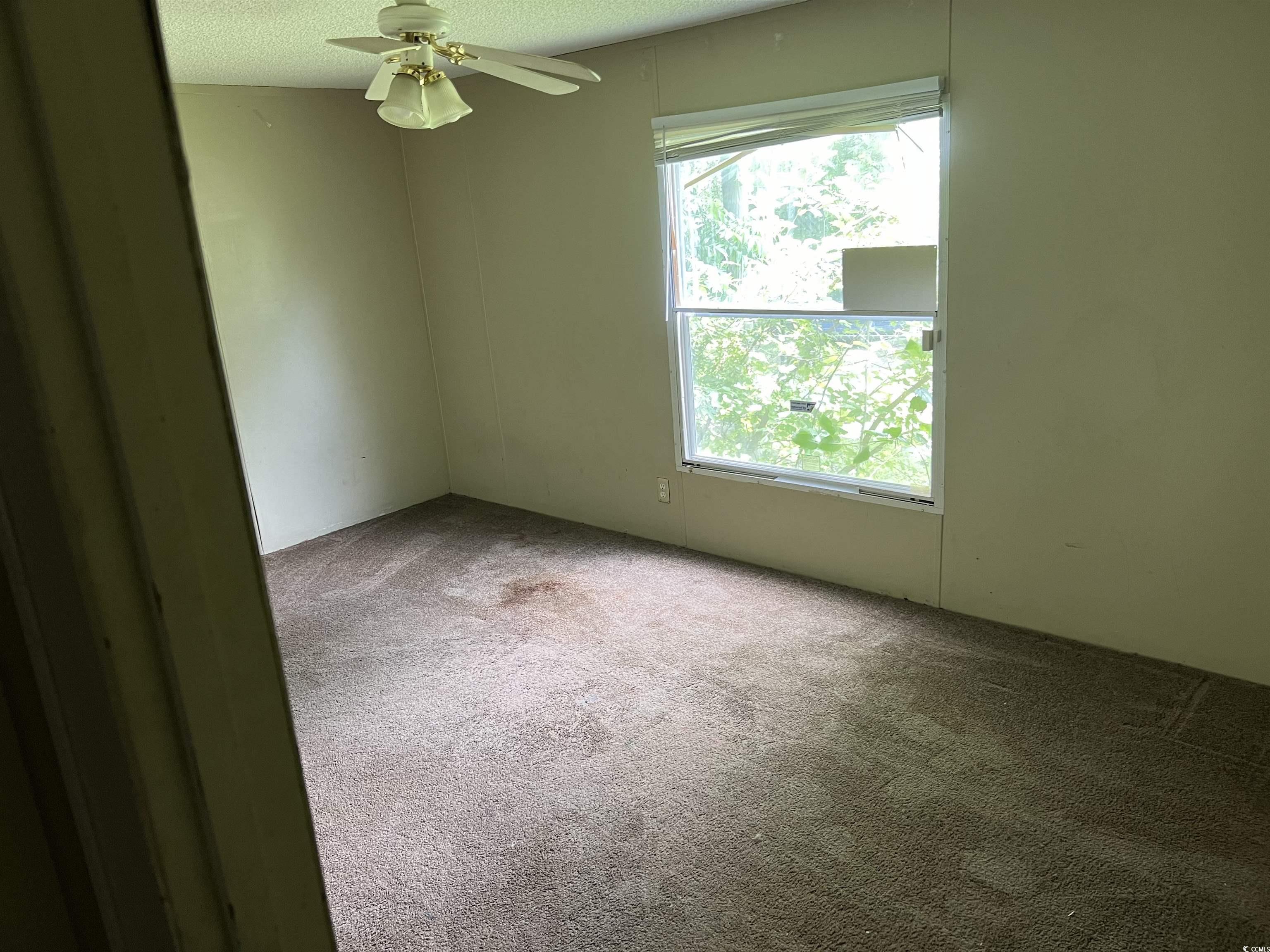 1118 Decatur Street Northeast Orangeburg, SC 29118 - Photo 12 of 14 Carpeted empty room featuring a textured ceiling and ceiling fan