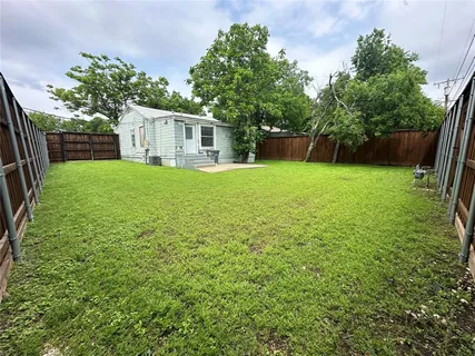 a view of a backyard with a garden and trees