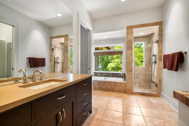 an aerial view of residential houses with outdoor space and trees