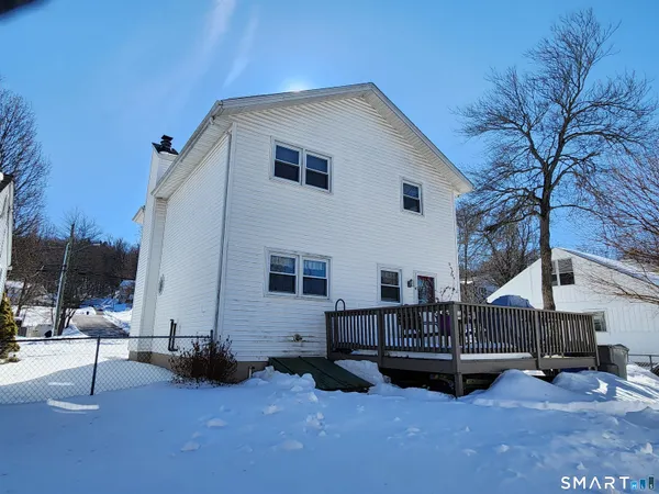 a view of a house with a yard and deck