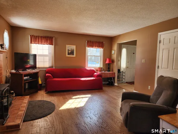 a bedroom with furniture and a flat screen tv