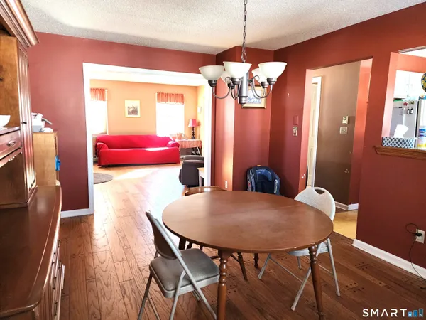 a view of a dining room with furniture and chandelier