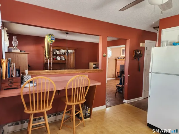 a bedroom with a bed and a refrigerator