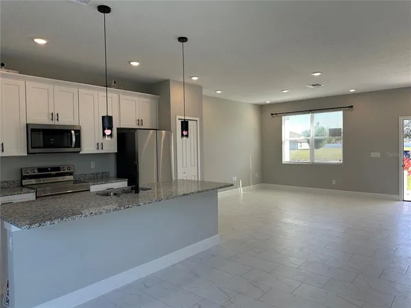 a view of a kitchen with a stove microwave and sink