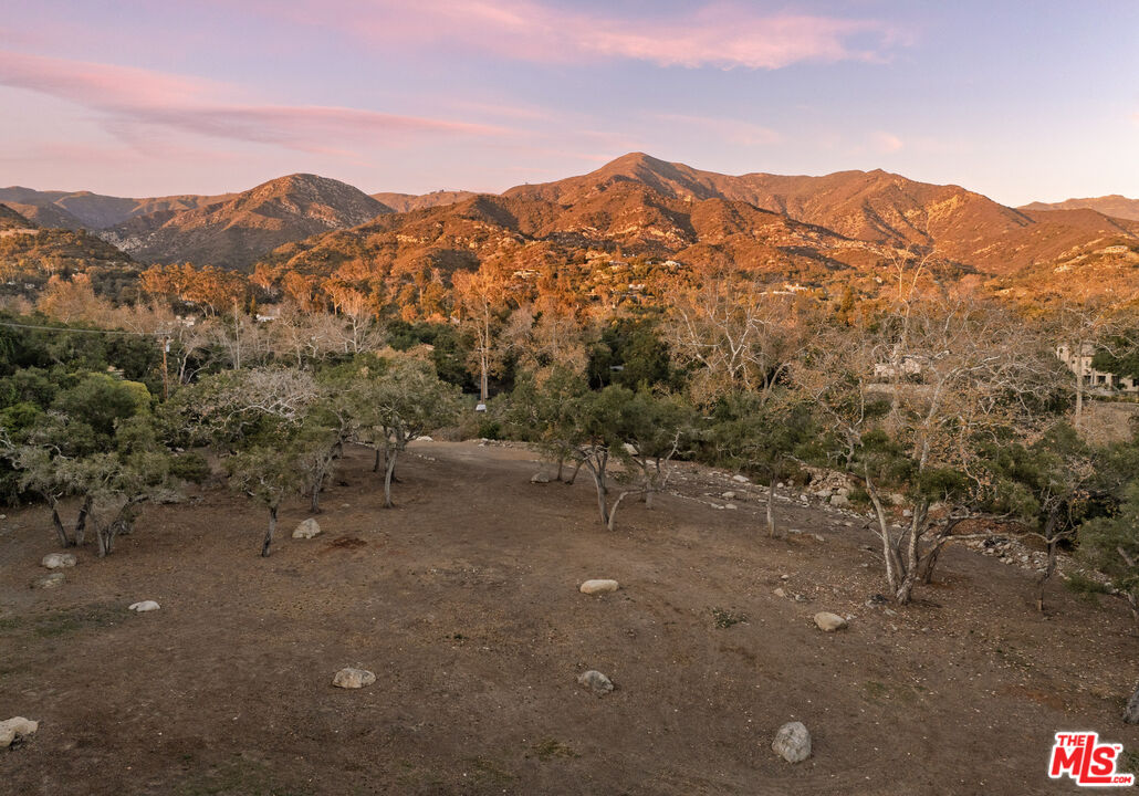 780 Ashley Road Santa Barbara, CA 93108 - Photo 2 of 21 a view of a dry yard with mountains in the background