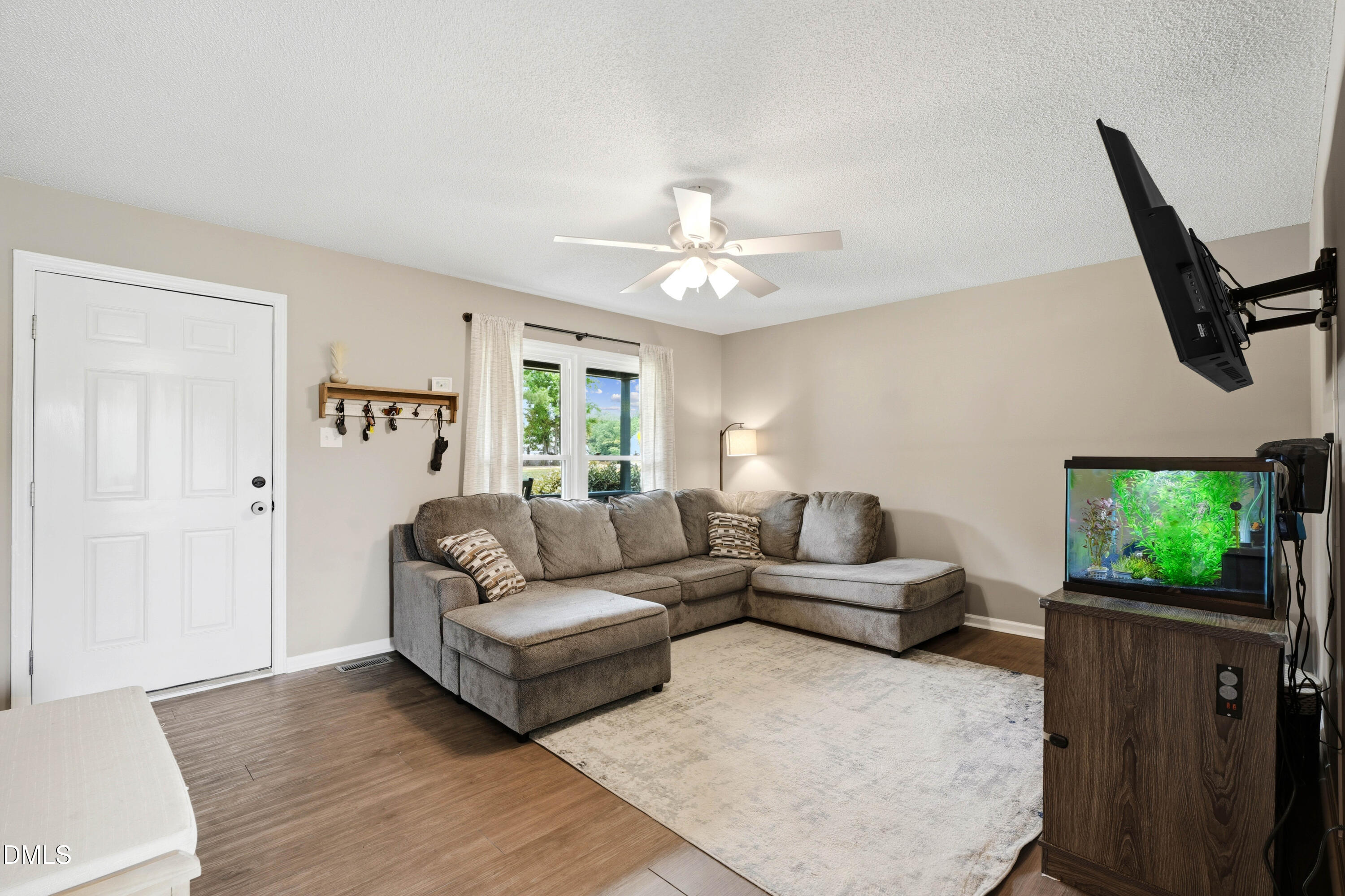 101 Stephenson Road Benson, NC 27504 - Photo 6 of 29 a living room with furniture and a flat screen tv