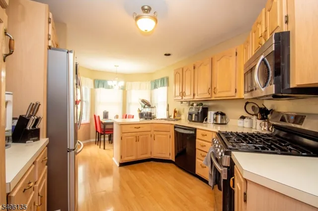 a kitchen with stainless steel appliances a stove sink and cabinets