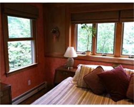 51 Bluff Road Bourne, MA 02561 - Photo 19 of 30 a bed sitting in a bedroom next to a window