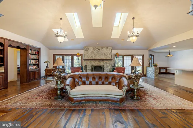 a living room with furniture fireplace and a large window