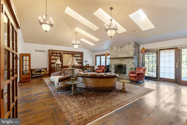 a living room with dining table furniture and a chandelier
