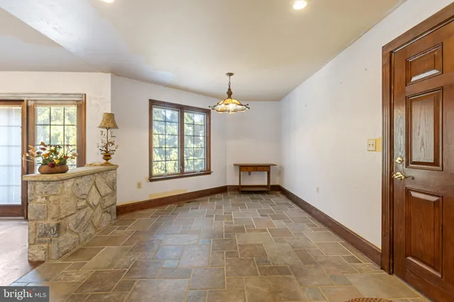 a large kitchen with stainless steel appliances a large counter top