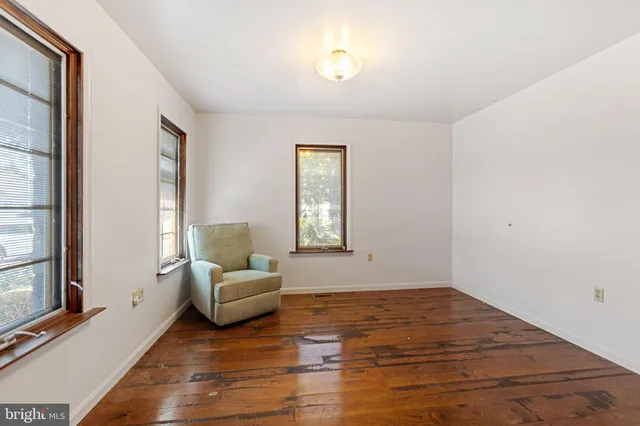a view of hallway with stairs and wooden floor