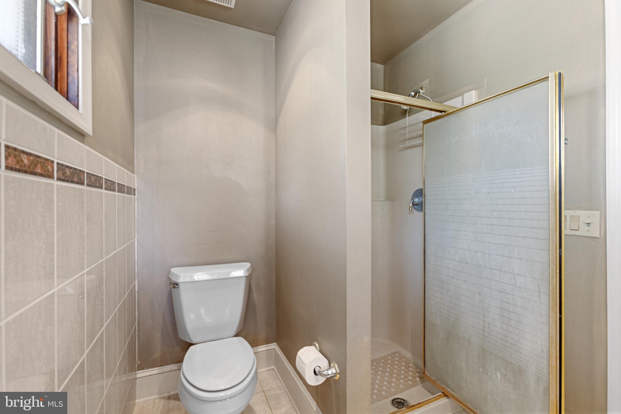 15 Baltray Road Dover, DE 19904 - Photo 39 of 59 a white toilet sitting next to a shower