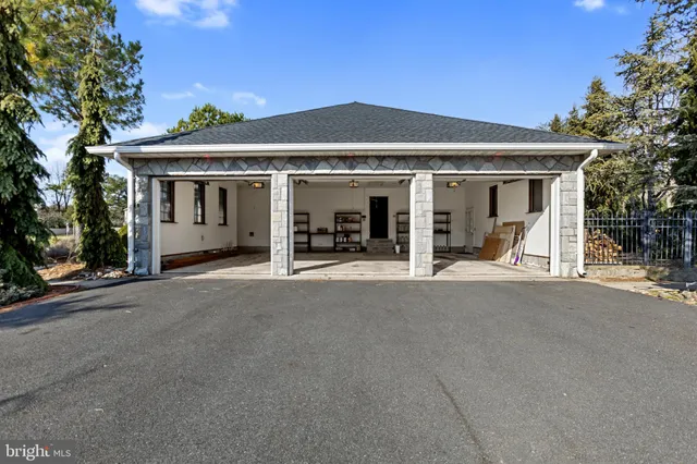 an aerial view of a house a garden and swimming pool