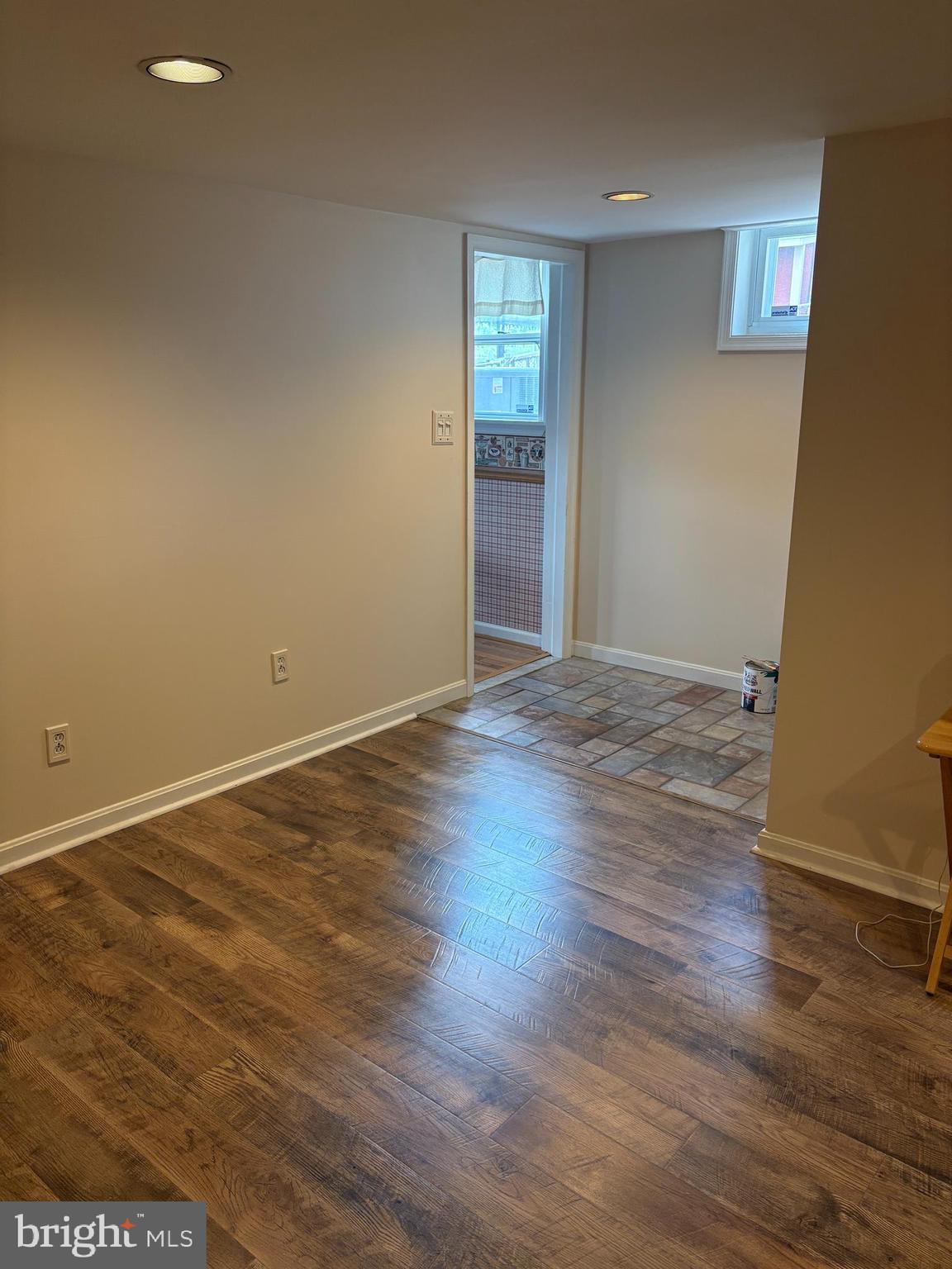 1809 Merritt Boulevard Baltimore, MD 21222 - Photo 15 of 33 an empty room with wooden floor and windows