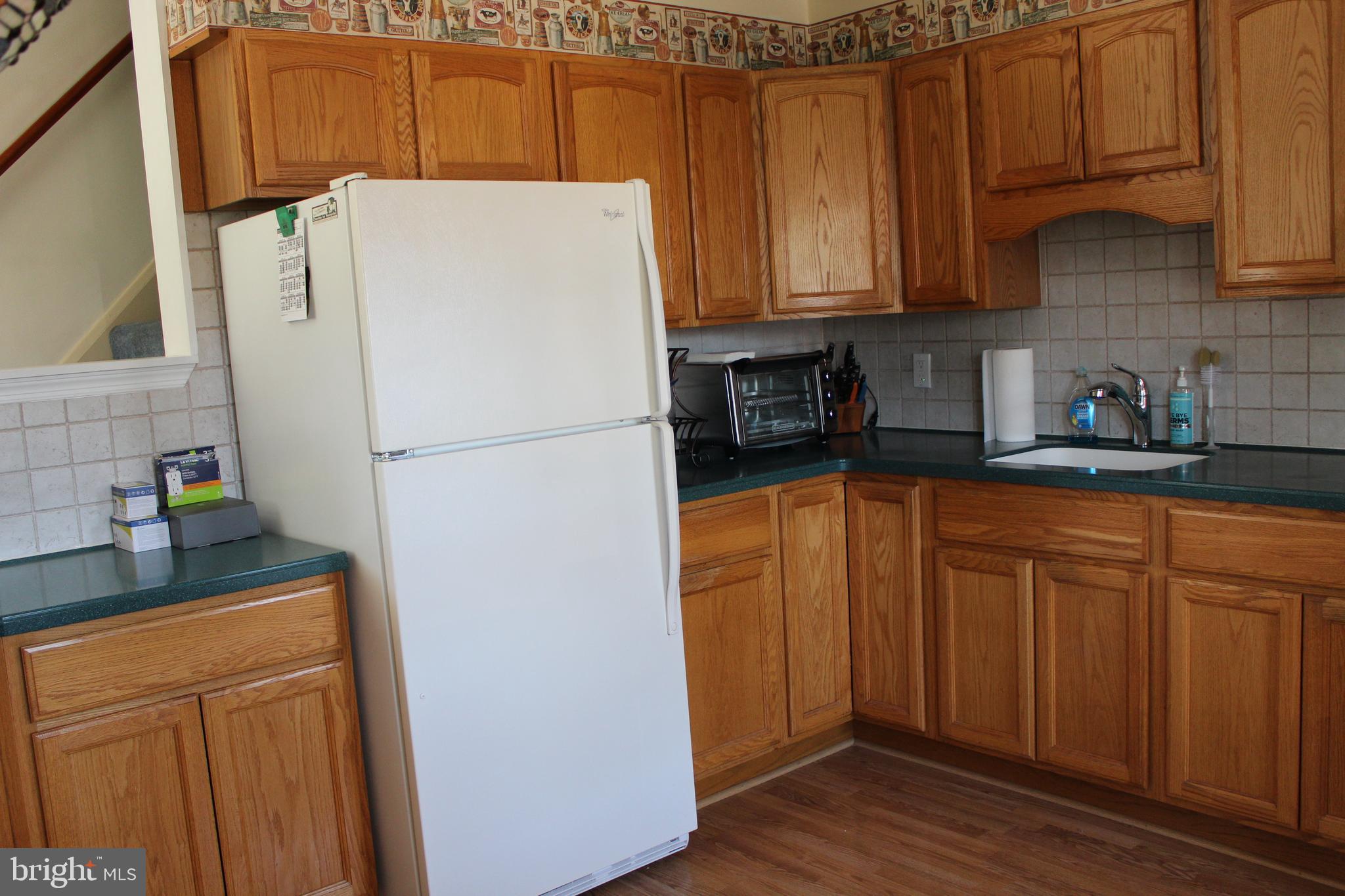 1809 Merritt Boulevard Baltimore, MD 21222 - Photo 7 of 33 a white refrigerator freezer sitting in a kitchen