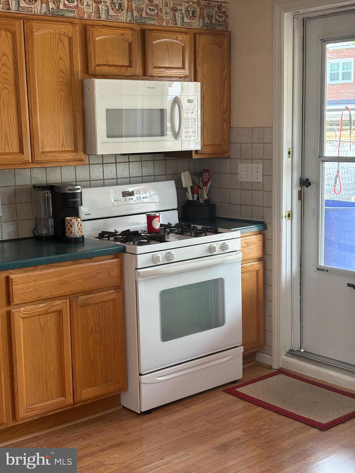 1809 Merritt Boulevard Baltimore, MD 21222 - Photo 9 of 33 a kitchen with stainless steel appliances granite countertop a stove a sink and a microwave