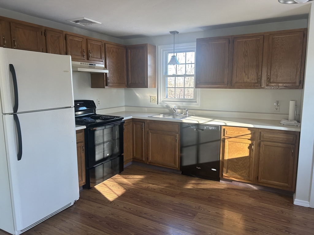 34 Uxbridge Road Sutton, MA 01590 - Photo 12 of 37 a kitchen with stainless steel appliances a refrigerator a sink a stove a microwave and cabinetry