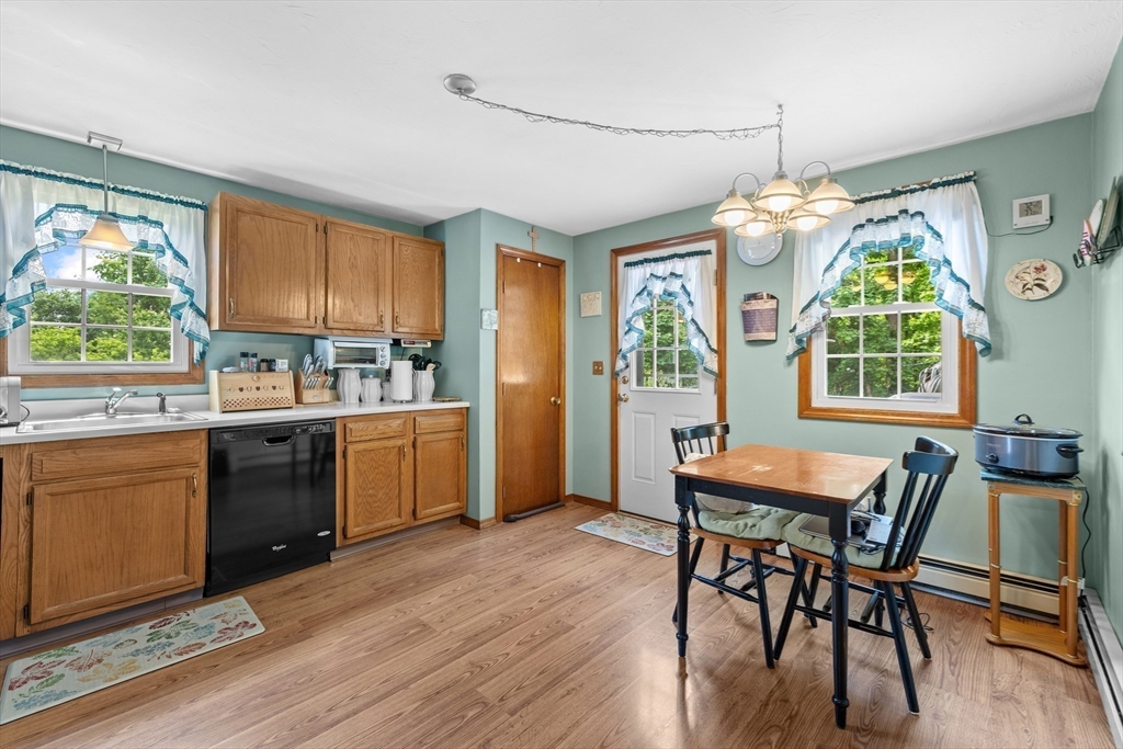 34 Uxbridge Road Sutton, MA 01590 - Photo 13 of 37 a kitchen with a table chairs sink and cabinets
