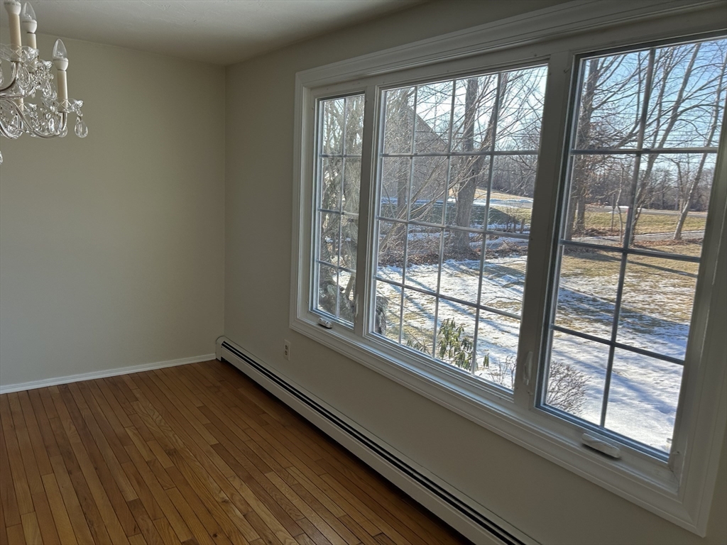 34 Uxbridge Road Sutton, MA 01590 - Photo 15 of 37 a view of empty room with wooden floor and fan