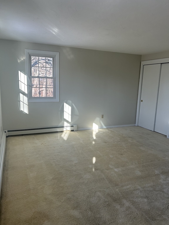 34 Uxbridge Road Sutton, MA 01590 - Photo 27 of 37 an empty room with windows and view of kitchen