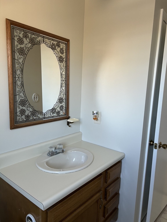 34 Uxbridge Road Sutton, MA 01590 - Photo 33 of 37 a bathroom with a sink a mirror and vanity