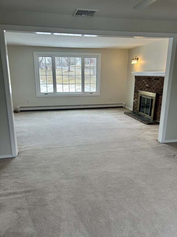 34 Uxbridge Road Sutton, MA 01590 - Photo 8 of 37 an empty room with a fireplace and windows