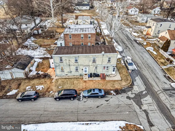 an aerial view of a building with parked cars
