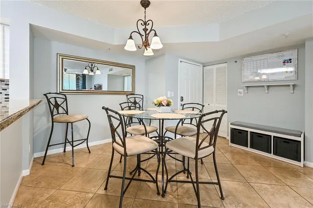 a view of a dining room with furniture and chandelier