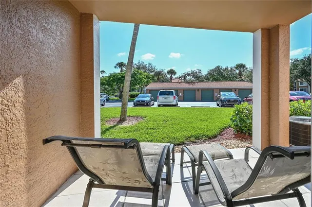 a view of a patio with table and chairs and potted plants