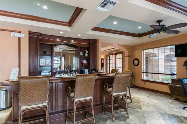 a room with pool table and windows