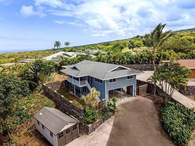 a aerial view of a house with a yard and plants