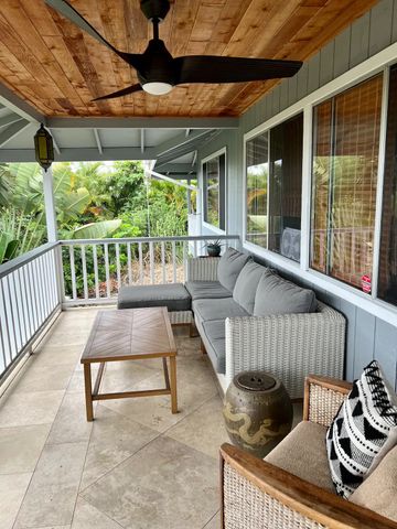 a view of a backyard with table and chairs under an umbrella