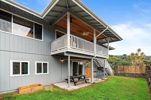 a view of a backyard with table and chairs under an umbrella