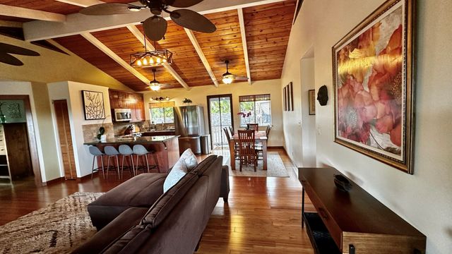 a living room with furniture ceiling fan and a rug