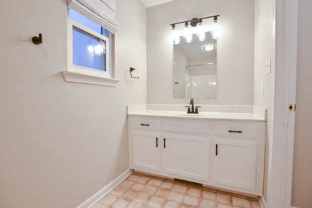a bathroom with a granite countertop toilet and a shower