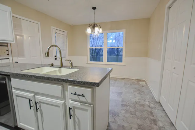 a kitchen with stainless steel appliances granite countertop a sink and refrigerator