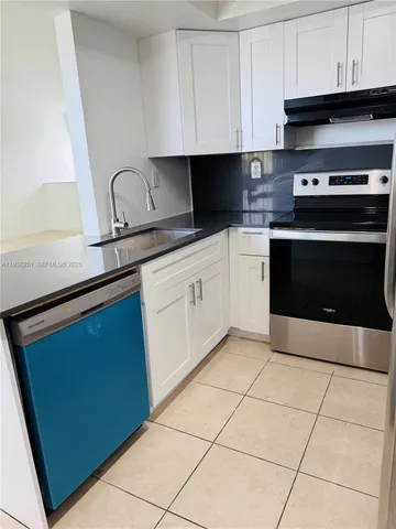 a kitchen with cabinets and appliances