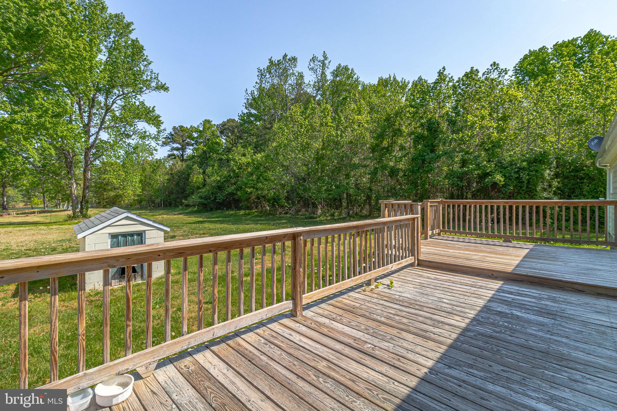 529 Taylors Beach Road Reedville, VA 22539 - Photo 51 of 57 Serene deck overlooking lush greenery.