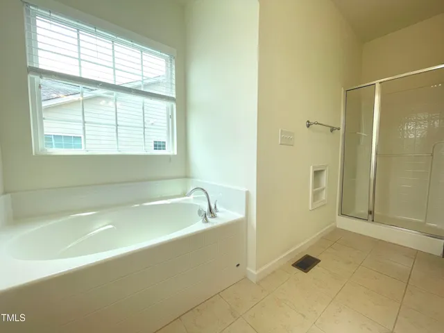 a bathroom with a bathtub and a shower