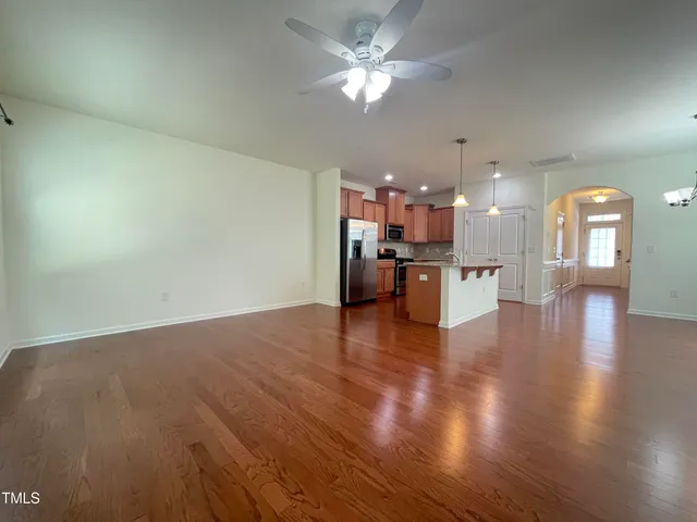 a kitchen with kitchen island a counter top space a sink and stainless steel appliances