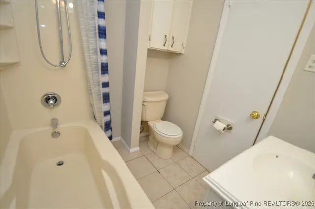 a white bath tub sitting next to a white sink
