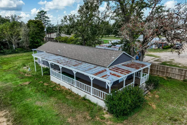 an aerial view of a house with a garden and lake view
